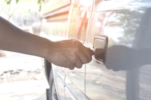 Normal Car key in men hand opening his car