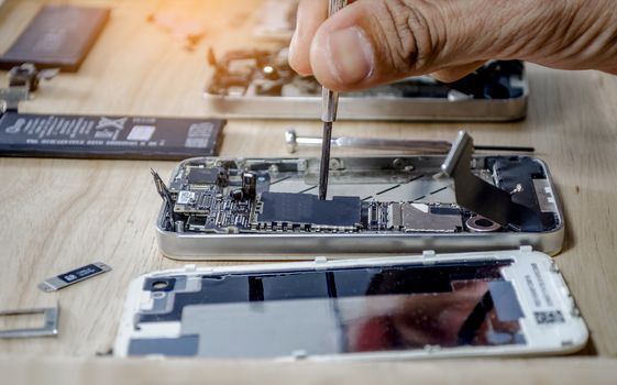 Phone motherboard repairs into the motherboard for smartphone By professional technician