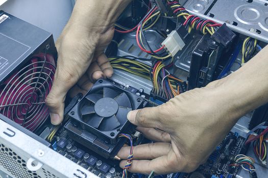 Technician computer repairing CPU cleaning for pc. In the computer service center