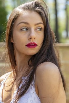 A gorgeous brunette model enjoys a spring day outdoors