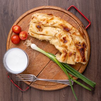 Traditional balkan breakfast - Borek or Burek pie with cheese aranged on wooden table