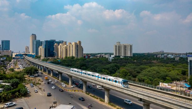 Gurgaon, India, 2020. Aerial shot of Rapid metro tracks in urban areas of Delhi NCR, Gurgaon, Noida with metro running on the tracks. A very useful addition to existing DMRC rail network