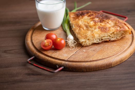 Traditional balkan breakfast - Borek or Burek pie with meat aranged on wooden table