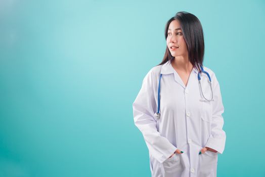 Asian doctor, happy beautiful young woman in uniform standing arms crossed, smiling with stethoscope looking out on blue background with copy space for text Medical health care staff service concept