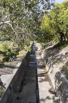 Sewage, water pipeline, river, drain. Street in the town of Claremont, Cape Town, South Africa.