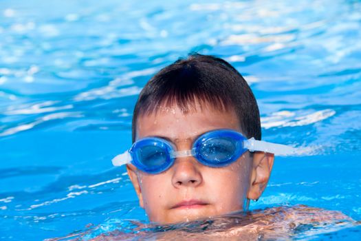 The boy in points floats in pool