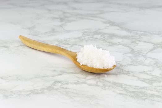sea salt in wooden spoon on Cement Tiles