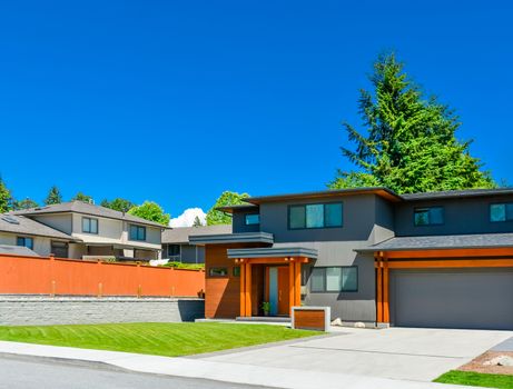 Newly renovated family house in Vancouver, British Columbia. Residential house with wide garage door and concrete driveway