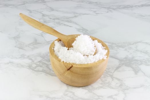 sea salt in wooden bowl and wooden spoon on Cement Tiles