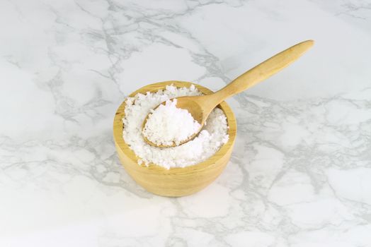 sea salt in wooden bowl and wooden spoon on Cement Tiles