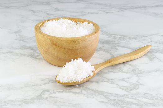sea salt in wooden bowl and wooden spoon on Cement Tiles