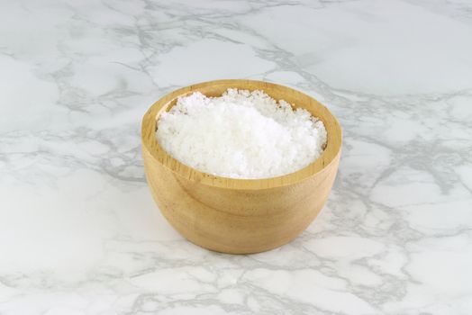 sea salt in wooden bowl on Cement Tiles