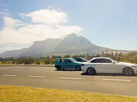 Drive by the Table Mountain in Cape Town, South Africa. Fast cars.