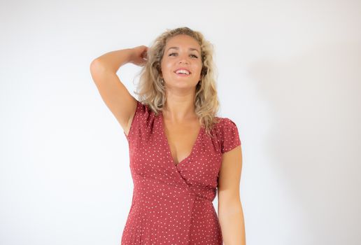 Beautiful smiling blonde woman in a red dress