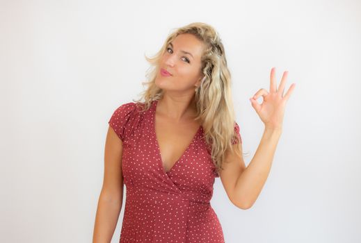 Beautiful smiling blonde woman in a red dress