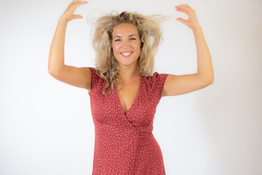 Beautiful surprised blonde woman in a red dress