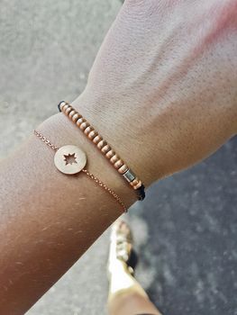 Hand with bracelets with compass and cardinal points, bronze for girls.