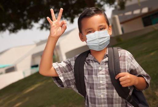 Hispanic Student Boy Wearing Face Mask with Backpack on School Campus.