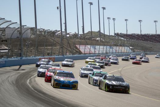 Kyle Busch (54) battles for position for the LS Tractor 200 at Phoenix Raceway in Avondale, Arizona.