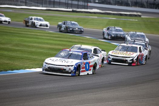 Mike Wallace (0) races for position for the Pennzoil 150 at the Brickyard at Indianapolis Motor Speedway in Indianapolis, .