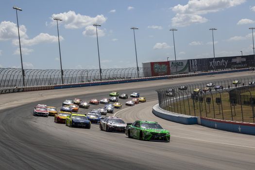 Kyle Busch (18) races for position the O'Reilly Auto Parts 500 at Texas Motor Speedway in Fort Worth, Texas.