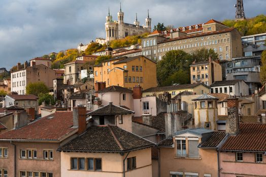 Lyon, France--November 6, 2017--Dwellings around the  Old City section of Lyon. The Basilica of Notre-Dame de Fourviere is at the top of the hill. Editorial Use Only.