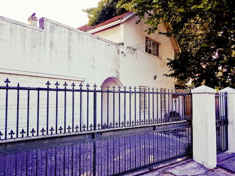 Nostalgic old purple and white building behind a fence in Cape Town, South Africa.