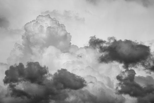Cloudscape texture background of moody black and white dramatic monochrome cumulus clouds