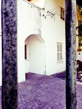 Nostalgic old purple and white building behind a fence in Cape Town, South Africa.