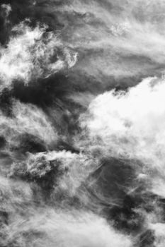 Cloudscape texture background of moody black and white dramatic monochrome cumulus clouds