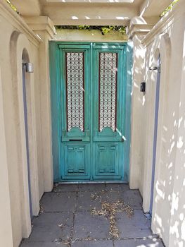 Beautiful old turquoise wooden door in the old building in Cape Town, South Africa.