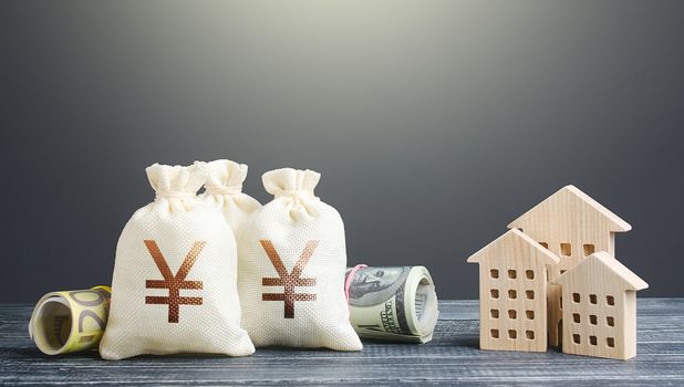 Yen Yuan money bags and residential buildings figures. Investments in real estate. Financing the construction and renovation of housing. Municipal budget management. Subsidies. Taxes. Mortgage loan