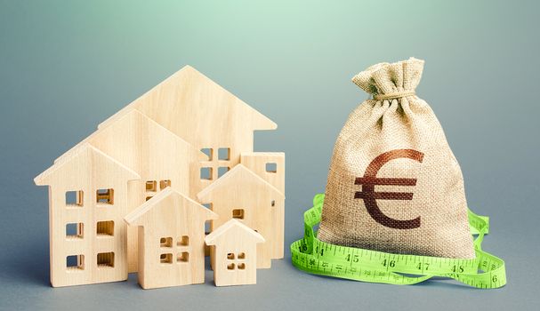 Residential houses and a euro money bag. Property real estate valuation. Buying and selling, fair price. City municipal budget. Calculation of expenses, construction and repair. Mortgage loan