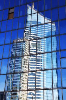 Reflection of a skyscraper office block in glass windows