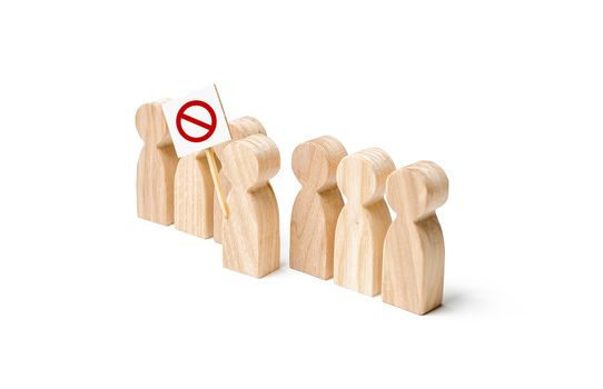 People is looking at a person holding a red prohibitory NO sign. Growth of protest moods, reaction of society to unpopular measures and laws. Populism and nationalism Disagreement and distrust