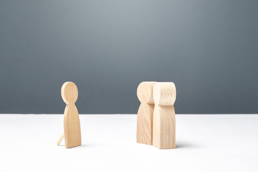 Two persons looking at a false human figure. Unreliability, deceit and fraud. Unworthy of trust and confusing people around. Communication difficulties, Absence. a Dummy.