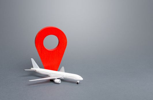 Passenger plane and red location indicator. Air travel. New rules for passengers transportation by air, quarantine measures. Support financial program for civil aviation in times of crisis downtime.