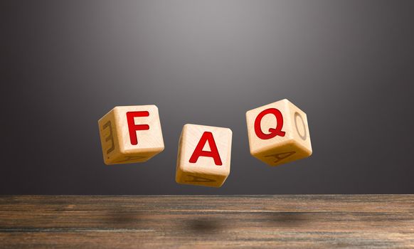 Wooden blocks make word abbreviation FAQ (frequently asked questions). Convenient form of answers explanations for users and customers. Instructions and rules. Avoid frequent errors, misunderstandings