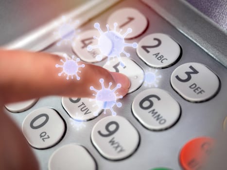 Finger pressing on number button on ATM machine with virus floating around. Virus infection spread disease concept.