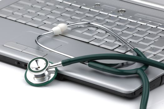 A stethoscope next to a laptop signifying the relationship of information technology and medicine