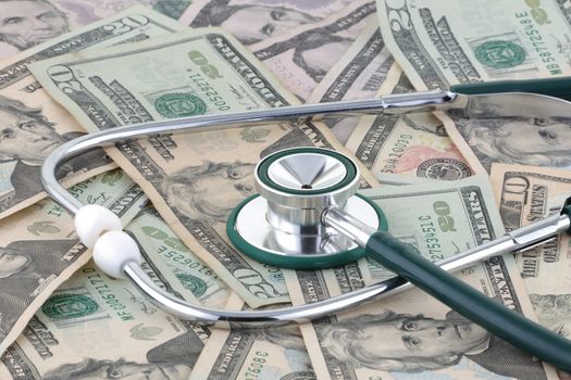 A medical stethoscope on a pile of money signifying the relationship of money and medicine