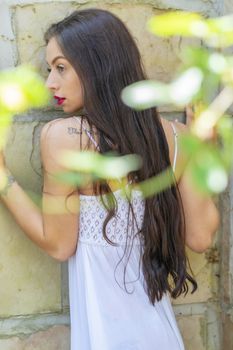 A gorgeous brunette model enjoys a spring day outdoors