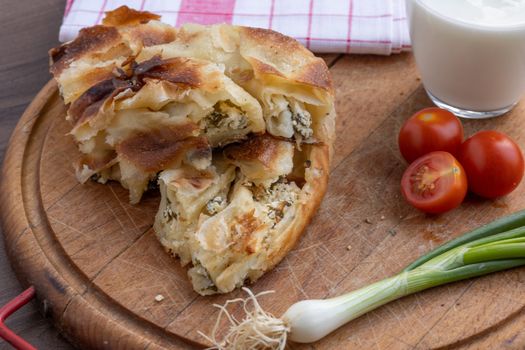 Balkan breakfast - Borek or Burek pie with cheese aranged on wooden table