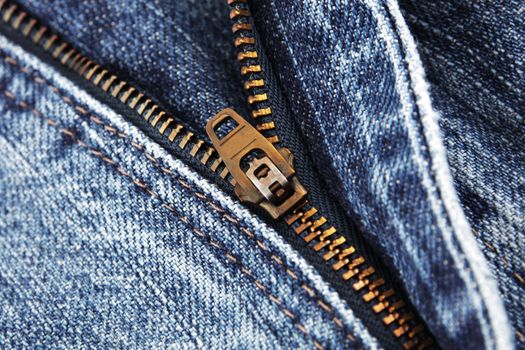 A blue jeans zip zipper close up detail with selective focus