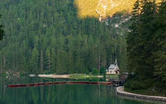 Mountain landscape with reflections on the Braies lake in Val Pusteria, South Tyrol Dolomites