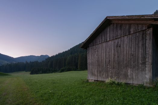 Wooden shed immersed in the mountain landscape of the Val Pusteria in the Dolomites of South Tyrol