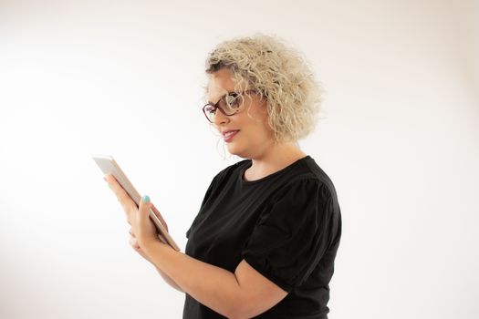 Blonde young woman smiling with glasses and gesturing