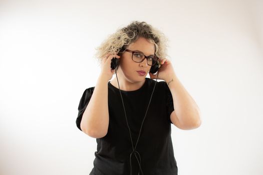 Blonde young woman smiling with headphones