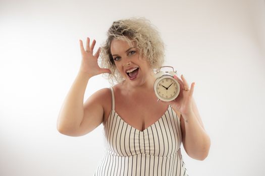 Blonde woman with a clock in her hand