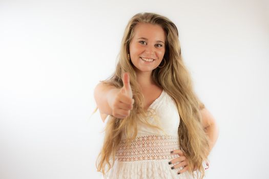 Pretty blonde girl in a white dress making the finger up gesture